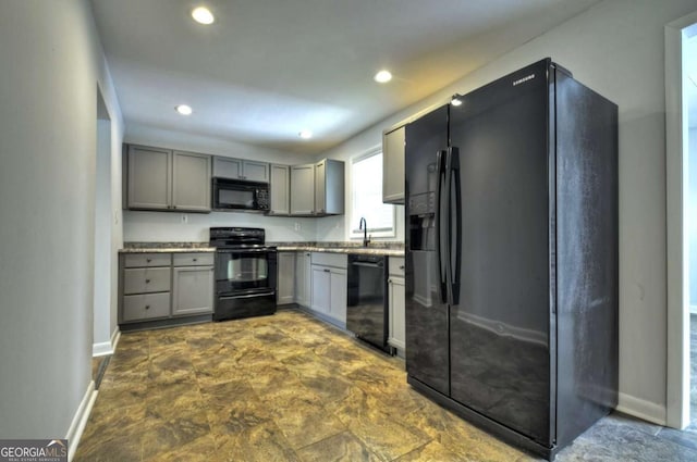 kitchen featuring black appliances, gray cabinetry, baseboards, recessed lighting, and a sink