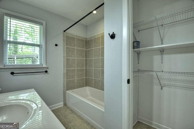 full bath with baseboards, a walk in closet, tile patterned floors, shower / tub combination, and recessed lighting
