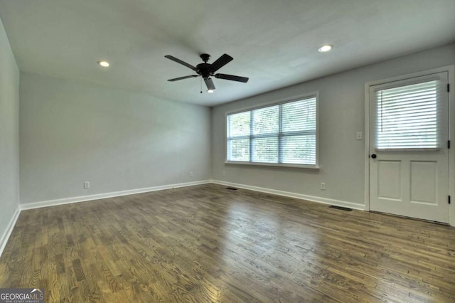 empty room with baseboards, dark wood finished floors, a ceiling fan, and recessed lighting
