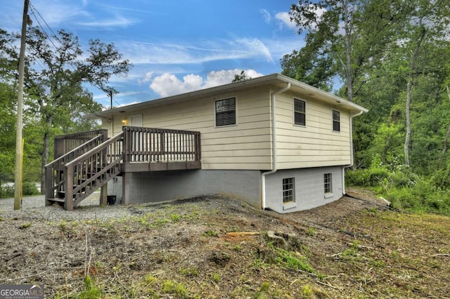 view of home's exterior featuring a deck and stairway