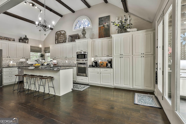 100 Rosemont, Peachtree City, GA 30269 - kitchen featuring stainless steel appliances, dark countertops, beam ceiling, a chandelier, and decorative backsplash
