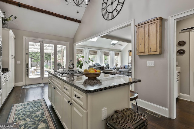 100 Rosemont, Peachtree City, GA 30269 - kitchen featuring ceiling fan, stainless steel gas cooktop, a kitchen island, dark wood-style floors, and beam ceiling