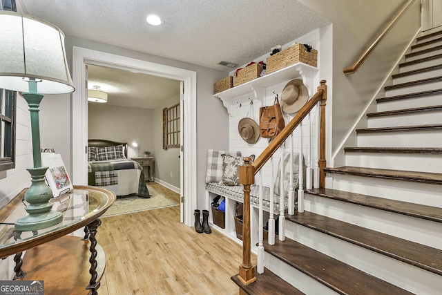 100 Rosemont, Peachtree City, GA 30269 - foyer entrance with a textured ceiling, light wood-style floors, stairway, and baseboards