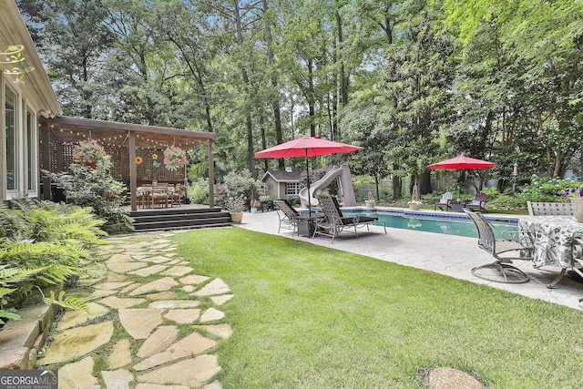 100 Rosemont, Peachtree City, GA 30269 - view of yard with a deck, an outdoor pool, a patio area, an outbuilding, and outdoor dining space