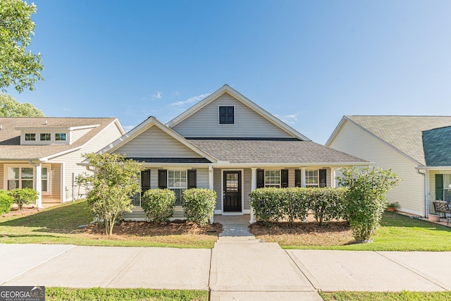 363 Chadwick Commons, Stockbridge, GA 30281 - traditional-style house with covered porch, a front yard, and a shingled roof