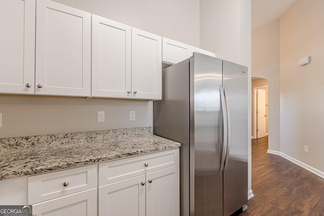 363 Chadwick Commons, Stockbridge, GA 30281 - kitchen with freestanding refrigerator, dark wood-style flooring, and white cabinetry