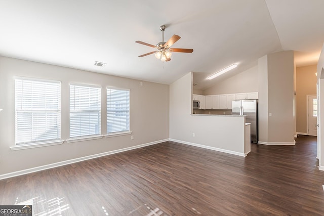 363 Chadwick Commons, Stockbridge, GA 30281 - unfurnished living room featuring ceiling fan, vaulted ceiling, dark wood-type flooring, and baseboards