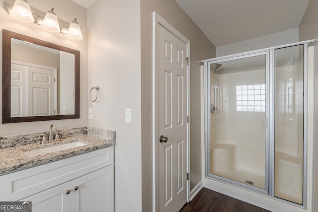 363 Chadwick Commons, Stockbridge, GA 30281 - bathroom with a shower stall, vanity, wood finished floors, and baseboards