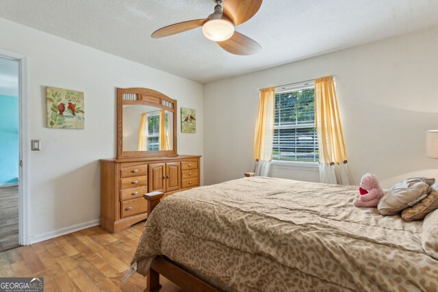 114 Pineneedle Ct, Kingsland, GA 31548 - bedroom with light wood-style floors, a ceiling fan, and baseboards