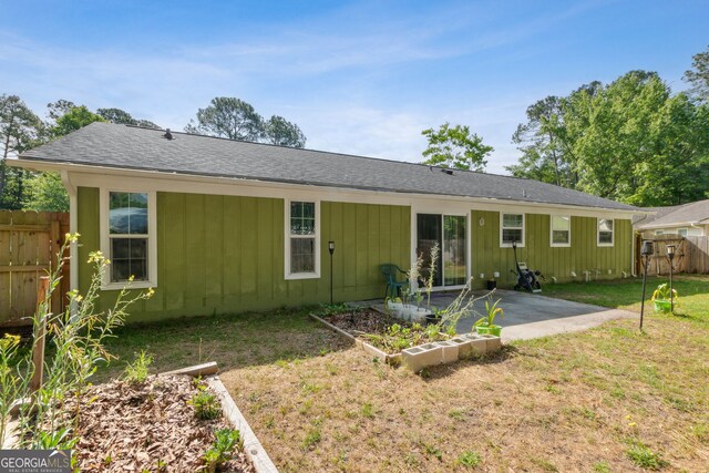 114 Pineneedle Ct, Kingsland, GA 31548 - rear view of property featuring a patio, board and batten siding, and roof with shingles
