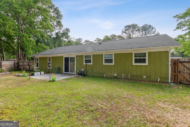114 Pineneedle Ct, Kingsland, GA 31548 - rear view of property featuring a patio area, board and batten siding, and a gate