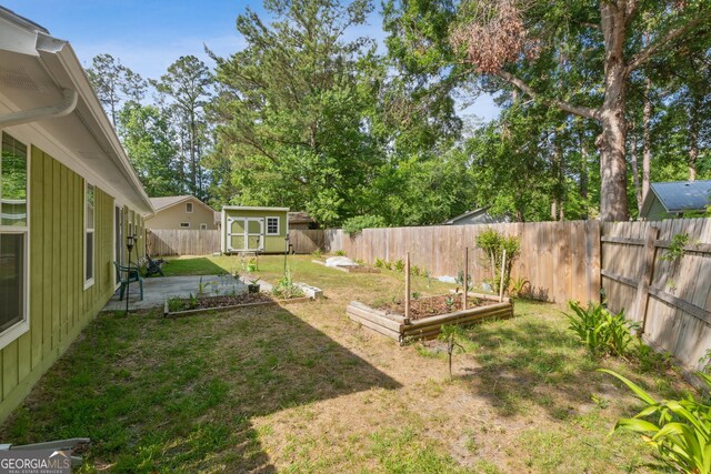 114 Pineneedle Ct, Kingsland, GA 31548 - view of yard with a garden, a storage shed, an outbuilding, and a patio