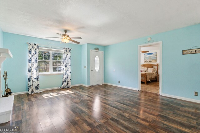 114 Pineneedle Ct, Kingsland, GA 31548 - unfurnished living room with ceiling fan, wood finished floors, a textured ceiling, and baseboards