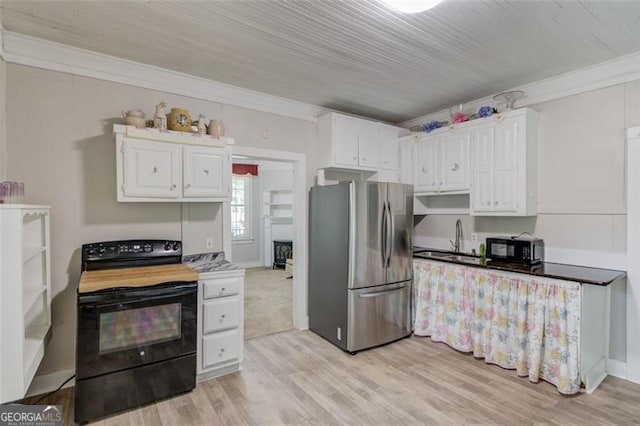 144 6th St, Monroe, GA 30655 - kitchen with black appliances, crown molding, white cabinets, a sink, and light wood-style floors
