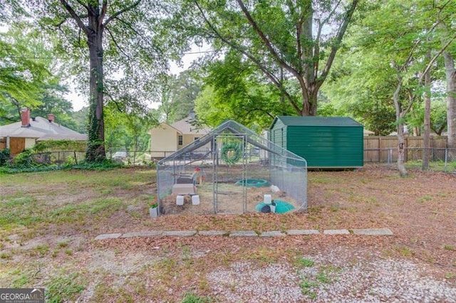 144 6th St, Monroe, GA 30655 - view of yard featuring fence, an outdoor structure, and exterior structure