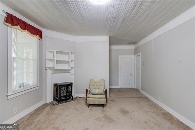 144 6th St, Monroe, GA 30655 - sitting room with a wood stove, carpet, crown molding, and baseboards