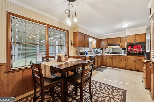 dining room featuring plenty of natural light, crown molding, and light tile patterned floors