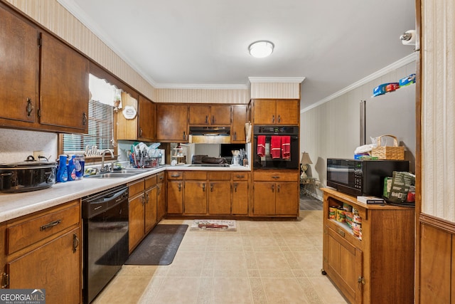 kitchen with black appliances, a sink, crown molding, under cabinet range hood, and brown cabinets