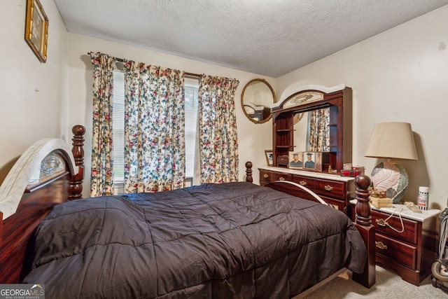 bedroom featuring carpet and a textured ceiling