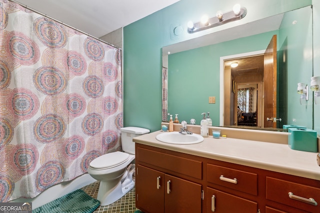 full bathroom featuring toilet, vanity, and tile patterned flooring