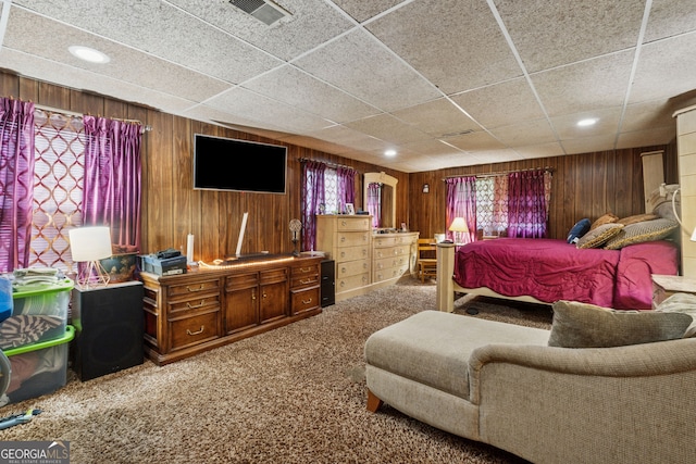 carpeted bedroom featuring wooden walls and recessed lighting