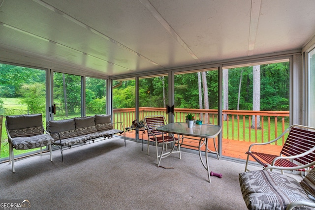 sunroom / solarium featuring an outdoor hangout area and outdoor dining area