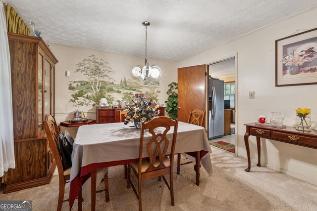 dining space featuring light carpet, a chandelier, a textured ceiling, crown molding, and baseboards