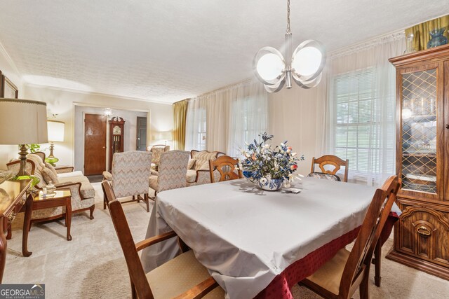 dining area featuring light carpet, a chandelier, a textured ceiling, and crown molding