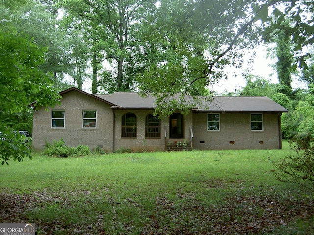 981 E Atlanta Rd, Stockbridge, GA 30281 - rear view of house featuring crawl space, a yard, and brick siding