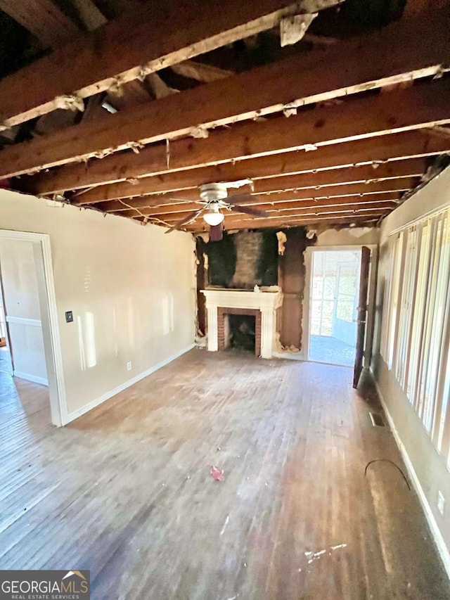 1386 Bluefield Dr SW, Atlanta, GA 30310 - unfurnished living room with wood finished floors, a ceiling fan, and a fireplace