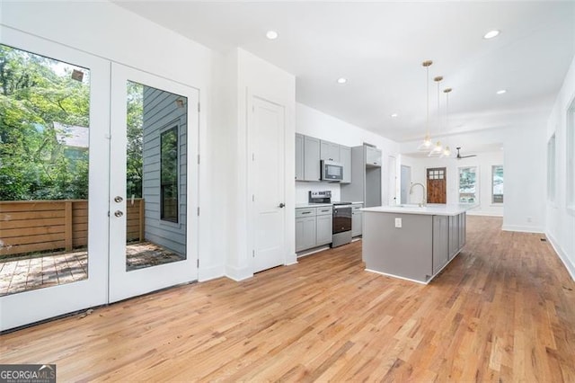 140 Racine St, Atlanta, GA 30314 - kitchen with stainless steel appliances, gray cabinetry, light countertops, light wood-type flooring, and recessed lighting