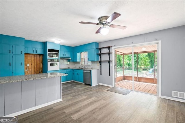 6997 Vesta Brook Dr, Morrow, GA 30260 - kitchen featuring stainless steel appliances, open shelves, ceiling fan, blue cabinetry, and healthy amount of natural light