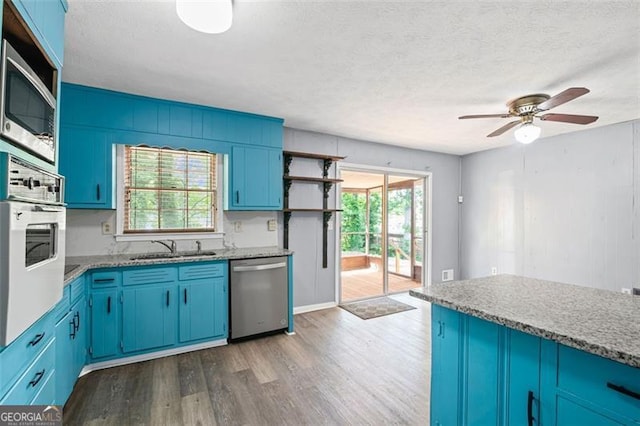 6997 Vesta Brook Dr, Morrow, GA 30260 - kitchen with stainless steel appliances, open shelves, blue cabinets, wood finished floors, and a textured ceiling