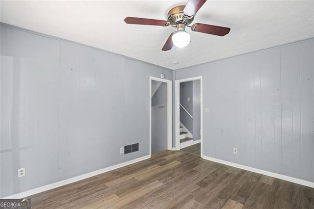 6997 Vesta Brook Dr, Morrow, GA 30260 - empty room featuring wood finished floors, ceiling fan, stairs, and baseboards