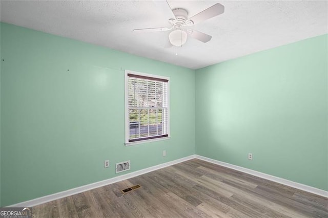 6997 Vesta Brook Dr, Morrow, GA 30260 - unfurnished room with wood finished floors, baseboards, a ceiling fan, and a textured ceiling