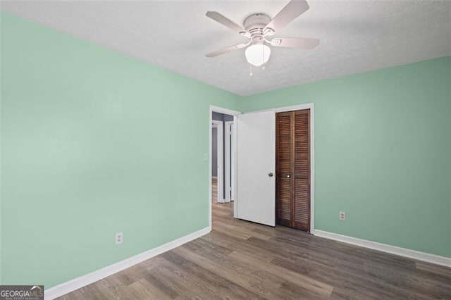 6997 Vesta Brook Dr, Morrow, GA 30260 - unfurnished bedroom featuring a closet, baseboards, wood finished floors, and ceiling fan