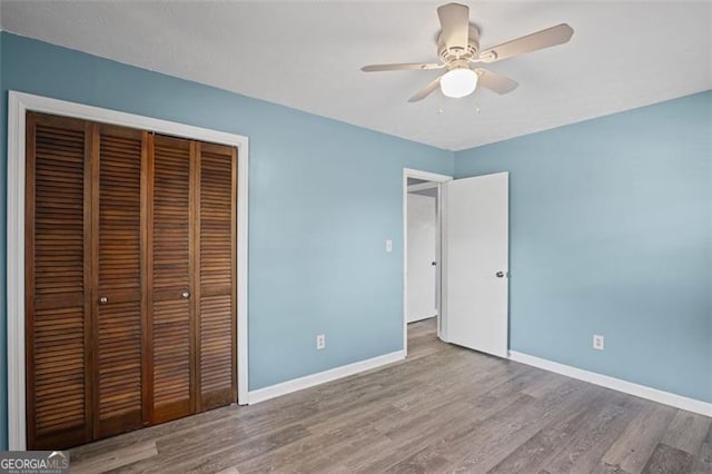 6997 Vesta Brook Dr, Morrow, GA 30260 - unfurnished bedroom with a closet, baseboards, wood finished floors, and ceiling fan