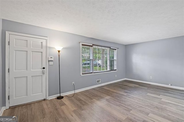 6997 Vesta Brook Dr, Morrow, GA 30260 - entrance foyer featuring wood finished floors, a textured ceiling, and baseboards