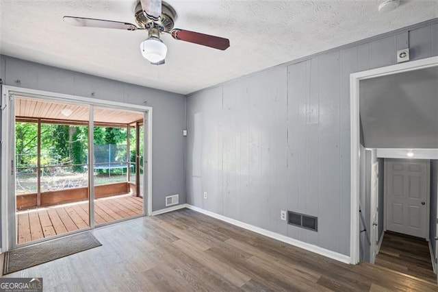 6997 Vesta Brook Dr, Morrow, GA 30260 - empty room with wood finished floors, a ceiling fan, baseboards, and a textured ceiling