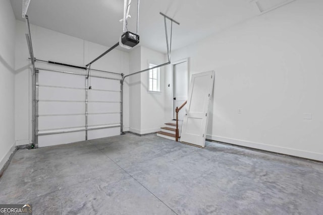 garage featuring a garage door opener and baseboards