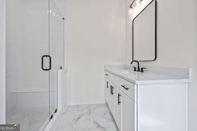 bathroom with marble look tile flooring, a stall shower, vanity, and baseboards