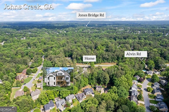 aerial view of residential area featuring a heavily wooded area