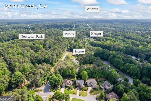 aerial perspective of suburban area featuring a heavily wooded area