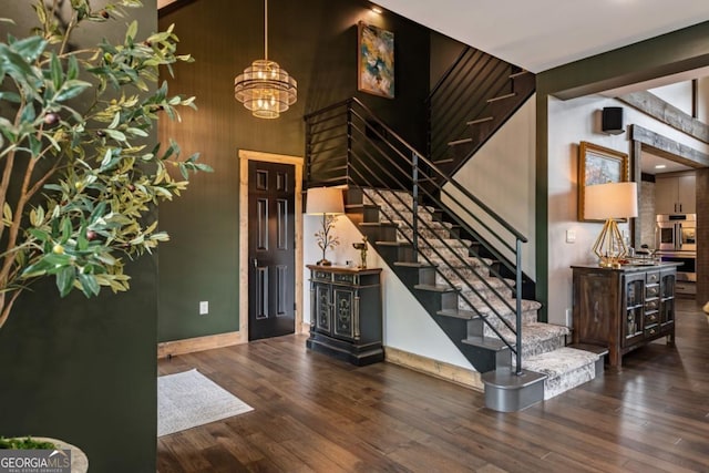 312 Charles Rd, Ellijay, GA 30540 - stairs featuring a chandelier, wood finished floors, and a towering ceiling