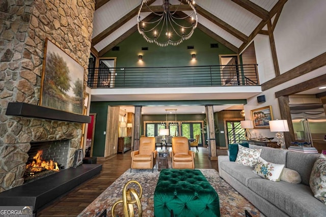 312 Charles Rd, Ellijay, GA 30540 - living area with a chandelier, high vaulted ceiling, wood finished floors, a stone fireplace, and beam ceiling