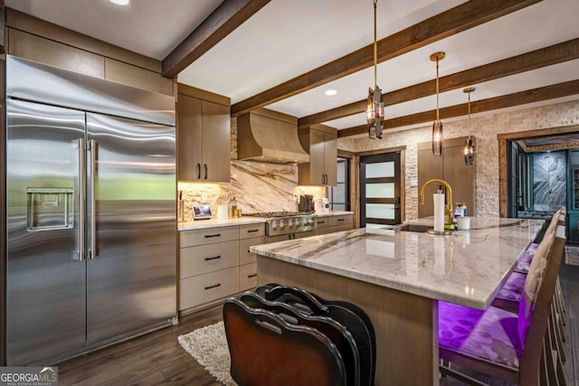 312 Charles Rd, Ellijay, GA 30540 - kitchen featuring stainless steel appliances, custom exhaust hood, dark wood-type flooring, beamed ceiling, and light stone counters