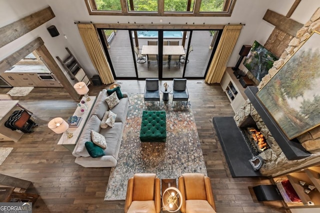 312 Charles Rd, Ellijay, GA 30540 - living area featuring a high ceiling, hardwood / wood-style floors, and a warm lit fireplace