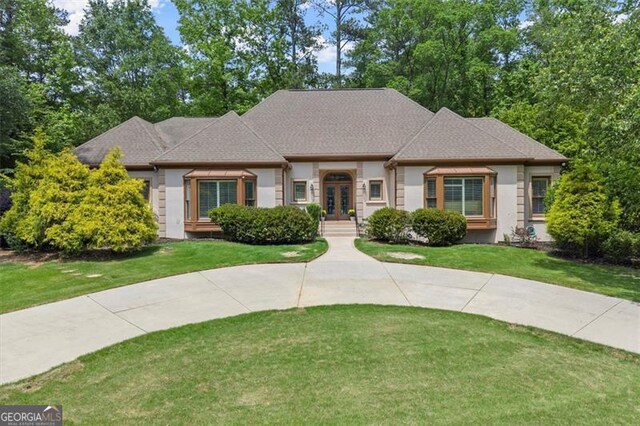 194 Sentinel Pl SE, Marietta, GA 30067 - french provincial home featuring french doors, a front yard, and roof with shingles