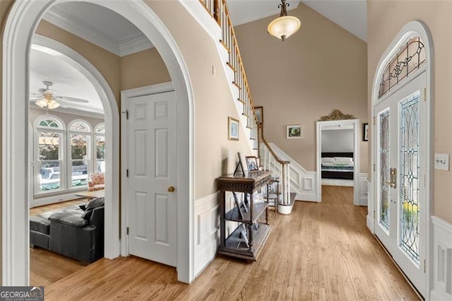194 Sentinel Pl SE, Marietta, GA 30067 - foyer entrance with stairs, light wood-style floors, wainscoting, a ceiling fan, and plenty of natural light