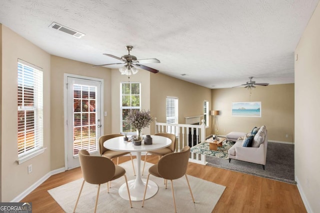 40 Wimberly Way, Covington, GA 30016 - dining room with a ceiling fan, wood finished floors, baseboards, and a textured ceiling